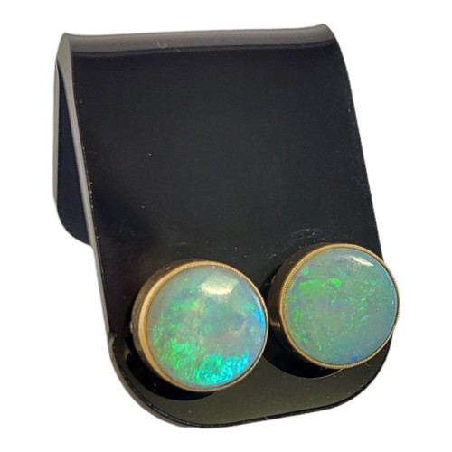 124 - A PAIR OF FIRE OPAL EARRINGS
In yellow metal mounts.
(diameter 1.3cm)

Condition: good throughout