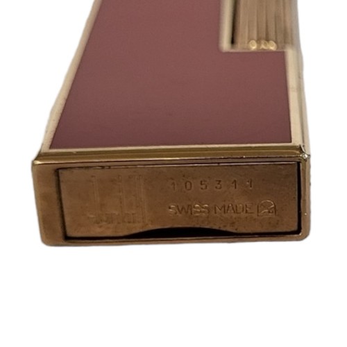 134 - DUNHILL, A VINTAGE GOLD PLATE AND RED LACQUER RECTANGULAR CIGARETTE LIGHTER
With hinged lid, marked ... 