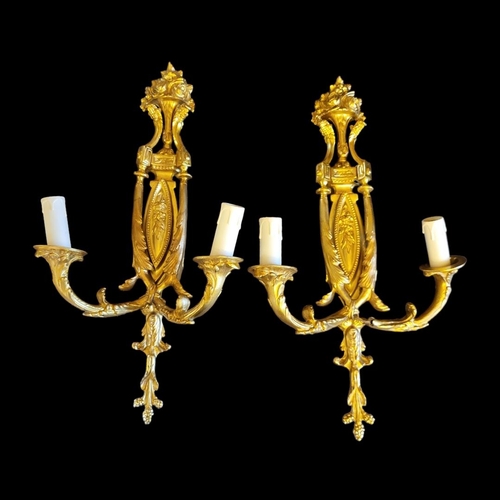 396 - A PAIR OF 20TH CENTURY GILT BRONZE TWIN BRANCH WALL SCONCES
Neoclassical shape applied with anthemio... 