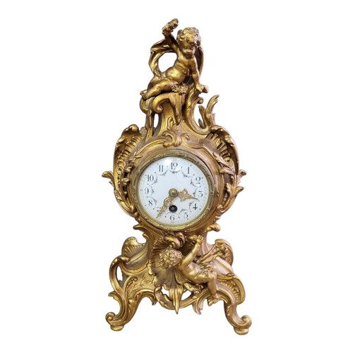 186 - AN EARLY 20TH CENTURY FRENCH GILT METAL FIGURAL MANTLE CLOCK
Organic form case with putti and painte... 