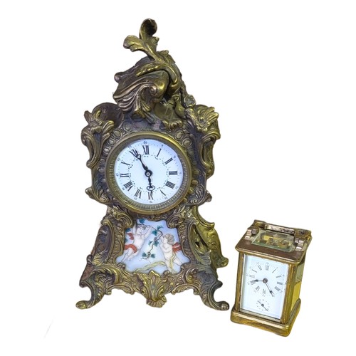 185 - A 20TH CENTURY BRASS AND PORCELAIN  MANTEL CLOCK
Set with painted porcelain dial, together with a gi... 