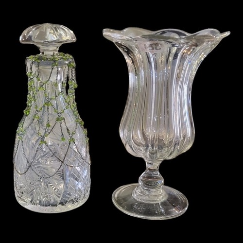 384 - A 19TH CENTURY GLASS CELERY VASE
Flared fluted form with circular base, together with a cut glass de... 