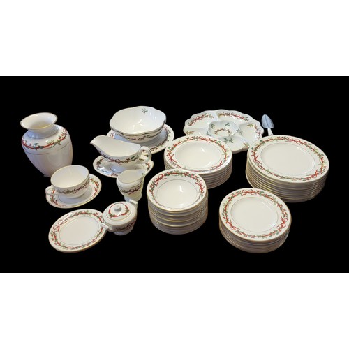 390 - ROYAL WORCESTER, A HOLLY RIBBONS PORCELAIN DINNER SERVICE
Comprising eleven dinner plates, eight sou... 