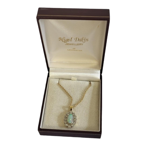 82A - AN 18CT GOLD, OPAL AND DIAMOND PENDANT NECKLACE
The cabochon cut opal edged with round cut diamonds ... 