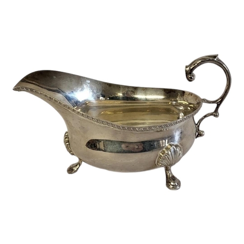 92A - AN EARLY 20TH CENTURY SILVER SAUCE BOAT
Having a single handle with shell firm tripod legs, hallmark... 