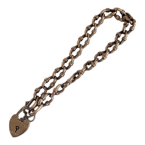 61A - AN EARLY 20TH CENTURY 9CT GOLD BRACELET
Having a heart form locket clasp and pierced links.
(approx ... 