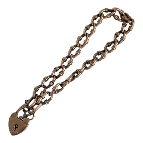 61A - AN EARLY 20TH CENTURY 9CT GOLD BRACELET
Having a heart form locket clasp and pierced links.
(approx ... 