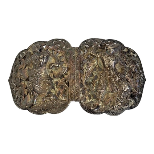 77A - AN EARLY 20TH CENTURY INDIAN SILVER NURSES BUCKLE
Having embossed figures and pierced decoration
(ap... 