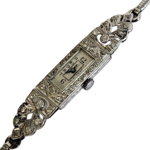 72A - AN ART DECO DECO, PLATINUM AND DIAMOND LADIES’ COCKTAIL WATCH
Rectangular form with pierced case set... 
