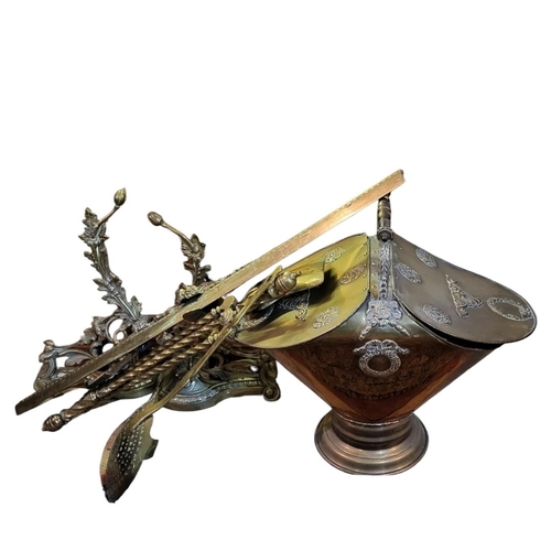 140 - A 19TH CENTURY BRASS COAL BUCKET
Having a carved wooden handle,twin compartments and embossed decora... 