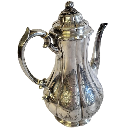 30 - A VICTORIAN SILVER COFFEE POT
Having a melon form finial,flutes to body and engraved decoration, hal... 