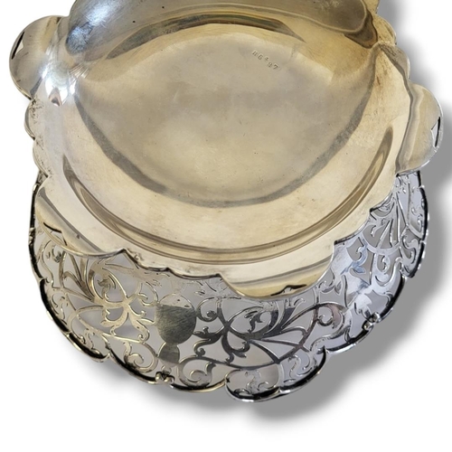 41 - AN EDWARDIAN SILVER CIRCULAR SWEETMEAT BASKET
With scrolled edge and  pierced decoration, hallmarked... 