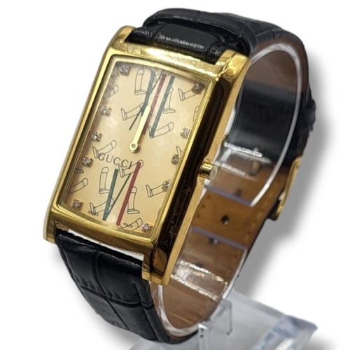 43A - GUCCI, A VINTAGE GOLD PLATED GENT’S WRISTWATCH
Rectangular form dial with Gucci monogram, on a black... 