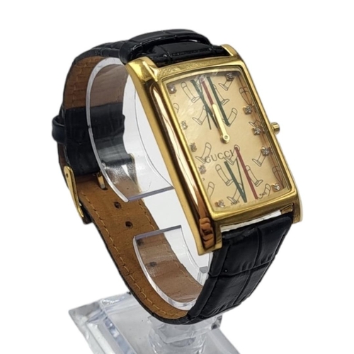 43A - GUCCI, A VINTAGE GOLD PLATED GENT’S WRISTWATCH
Rectangular form dial with Gucci monogram, on a black... 