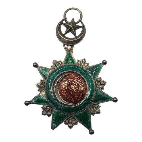 60 - A GOLD AND SILVER OTTOMAN EMPIRE ORDER OF OSMANIEH NECK BADGE, 1862 Silver seven pointed star with a... 