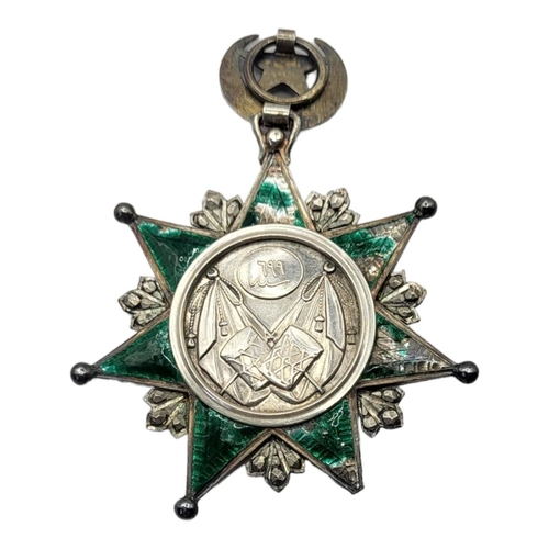 60 - A GOLD AND SILVER OTTOMAN EMPIRE ORDER OF OSMANIEH NECK BADGE, 1862 Silver seven pointed star with a... 