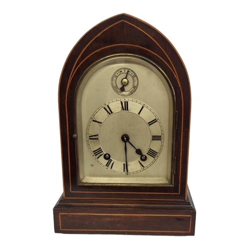 330 - A LATE 19TH CENTURY GOTHIC MAHOGANY AND BOXWOOD INLAID CLOCK
With silvered dial and chiming movement... 