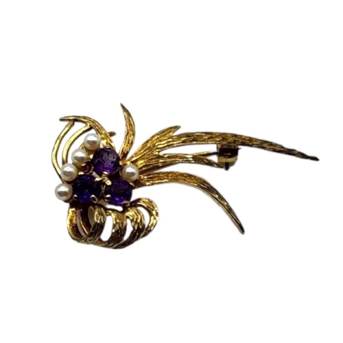 107 - A VINTAGE 9CT GOLD, AMETHYST AND SEED PEARL BROOCH
The cluster of three amethyst stones, edged with ... 