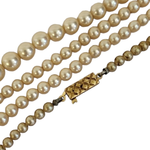 104 - A VINTAGE 9CT GOLD AND FAUX PEARL NECKLACE
The rectangular clasp with a graduated row of pearls.
(ap... 