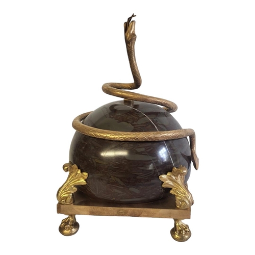 354 - A GILT METAL CENTREPIECE OF A SERPENT ENTWINING A MARBLE BALL 
Held by gilded acanthus leaves, raise... 