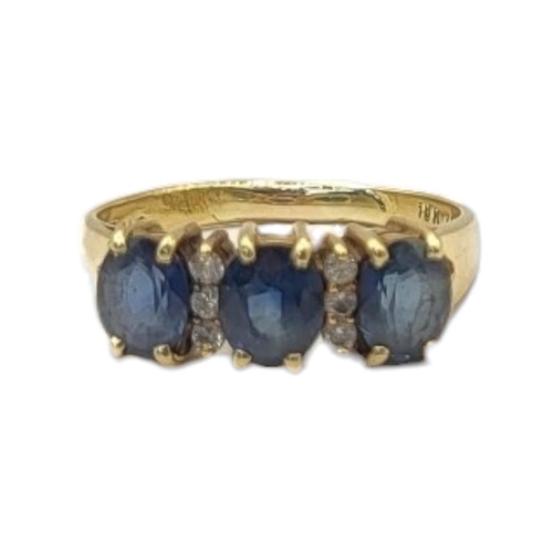 18 - AN 18CT GOLD, SAPPHIRE AND DIAMOND THREE STONE RING
Three oval cut stones interspersed with two rows... 