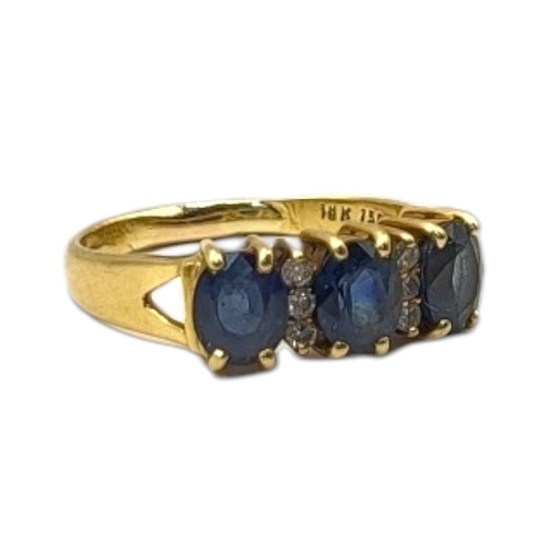 18 - AN 18CT GOLD, SAPPHIRE AND DIAMOND THREE STONE RING
Three oval cut stones interspersed with two rows... 