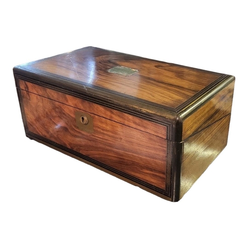 191A - A 19TH CENTURY WALNUT WRITING SLOPE
Having inlaid brass stringing, cartouche and escutcheon .
(appro... 