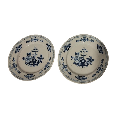 194 - A PAIR OF 18TH CENTURY DUTCH DELFT POTTERY CHARGER DISHES
Central cartouche of bamboo shoots and fau... 