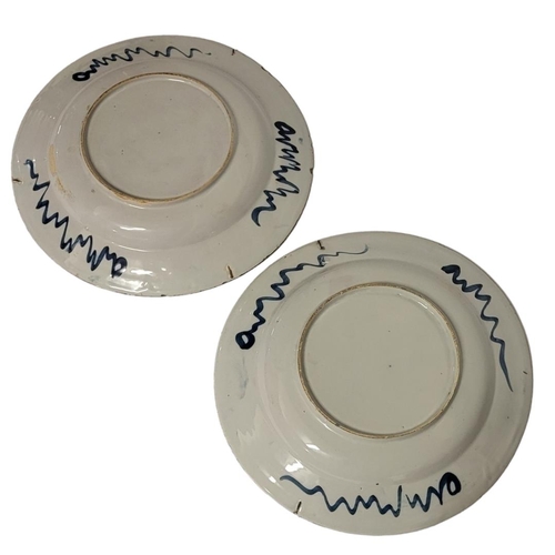 194 - A PAIR OF 18TH CENTURY DUTCH DELFT POTTERY CHARGER DISHES
Central cartouche of bamboo shoots and fau... 