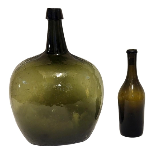 197 - A LARGE 18TH/EARLY 19TH CENTURY ITALIAN GREEN GLASS DEMIJOHN WINE BOTTLE
Having a tapered collar and... 