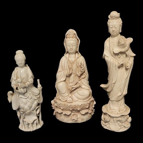 201 - A COLLECTION OF THREE  EARLY 20TH CENTURY CHINESE BLANC DE CHINE FIGURES OF GUANYIN
Standing pose cl... 