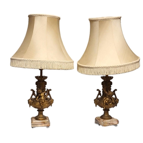 216 - A PAIR OF EARLY 20TH CENTURY FRENCH GILDED SPELTER CHERUBS LAMP BASES
Both having scrolling handles ... 