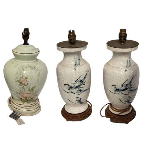 221 - TWO PAIRS OF 20TH CENTURY POTTERY LAMPS
A pair of blue and white crackle glaze lamps, hand painted w... 