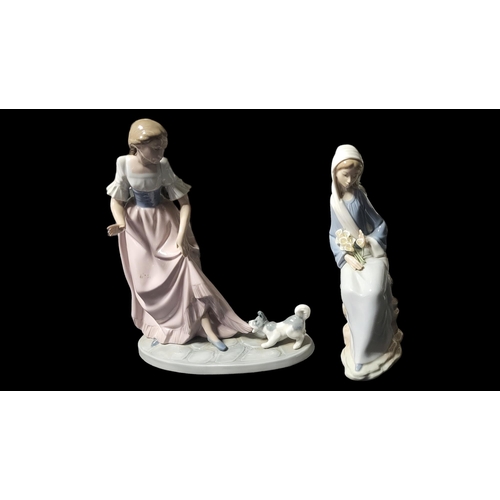 233 - LLADRO, A PORCELAIN FIGURE OF A SEATED MADONNA WITH HOLY LILIES 
Painted in monochrome glazes, along... 