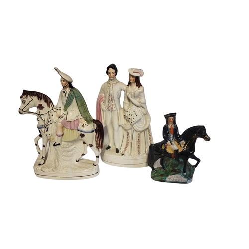 237 - A VICTORIAN STAFFORDSHIRE FIGURAL GROUP MODELLED AS A MARRIED COUPLE 
Highlighted with gilt, a Staff... 