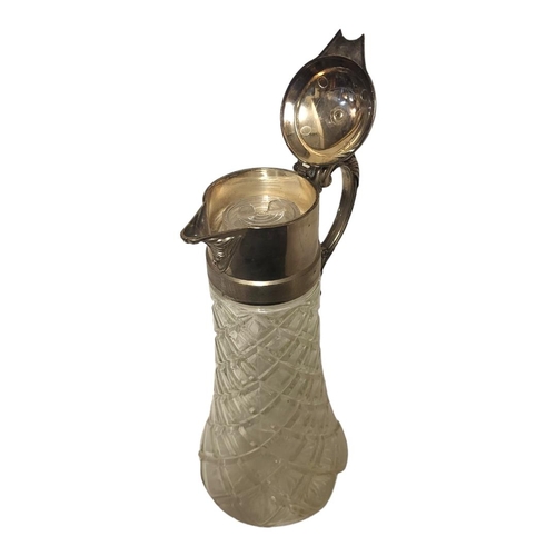 303 - A 20TH CENTURY SILVER PLATE AND GLASS CLARET JUG
Having a single handle and moulded facets to glass ... 