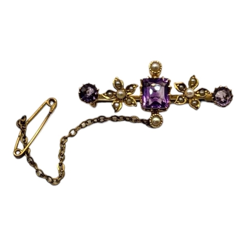 40 - A LATE 19TH/EARLY 20TH CENTURY 15CT GOLD, AMETHYST AND MICRO SEED PEARL BAR BROOCH
Set with an openw... 