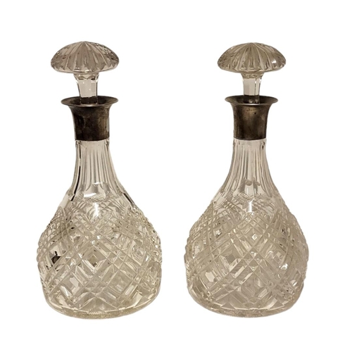 45 - MAPPIN AND WEBB, A PAIR OF EARLY 20TH CENTURY SILVER AND CUT GLASS DECANTERS
Having mushroom form st... 