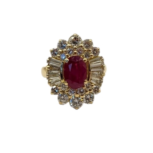 50 - AN 18CT GOLD, RUBY AND DIAMOND CLUSTER RING
The central oval cut ruby,edged with baguette and round ... 