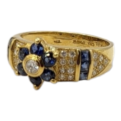 5A - AN 18CT GOLD, DIAMOND AND SAPPHIRE RING
The central round cut diamond,edged with sapphires flanked b... 