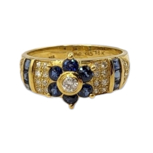 5A - AN 18CT GOLD, DIAMOND AND SAPPHIRE RING
The central round cut diamond,edged with sapphires flanked b... 