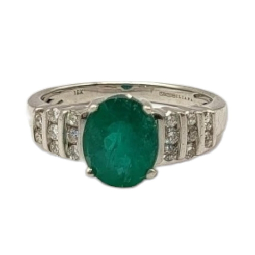 61 - AN 18CT WHITE GOLD, EMERALD AND DIAMOND CLUSTER RING
The single oval cut emerald with diamond set st... 