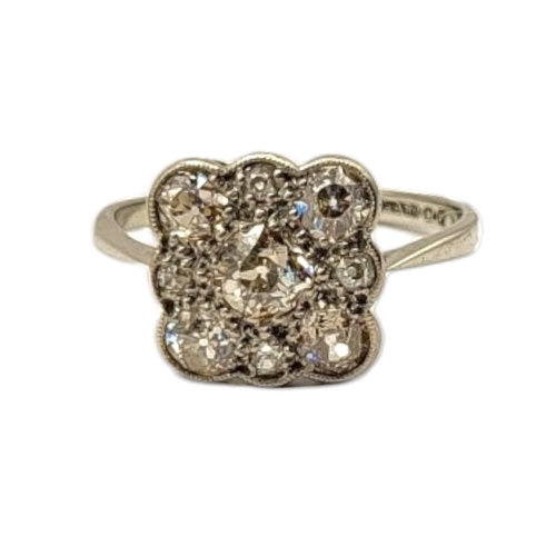 62 - AN EARLY 20TH CENTURY 18CT WHITE GOLD DIAMOND CLUSTER RING
The arrangement of round cut diamonds in ... 