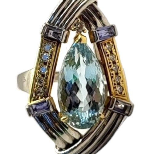 63 - AN 18CT BICOLOUR GOLD, AQUAMARINE AND DIAMOND CLUSTER RING
The central pear cut aquamarine flanked b... 