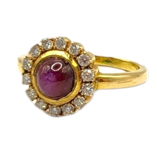 67 - A VINTAGE YELLOW METAL, STAR RUBY AND DIAMOND AND CLUSTER RING
The cabochon cut ruby edged with roun... 