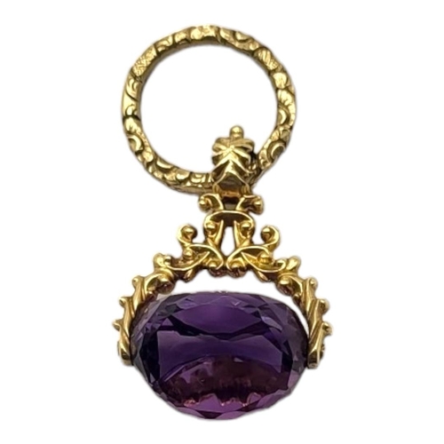 85 - A VICTORIAN YELLOW METAL AND AMETHYST SWIVEL FOB
Faceted cut stone in a textured mount.
(approx 4cm ... 