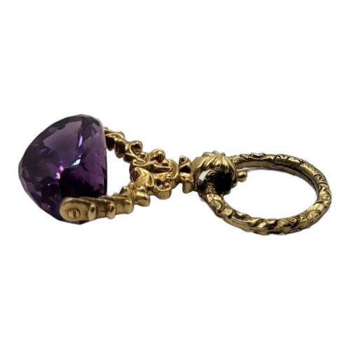 85 - A VICTORIAN YELLOW METAL AND AMETHYST SWIVEL FOB
Faceted cut stone in a textured mount.
(approx 4cm ... 