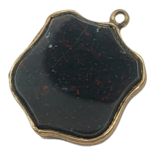 89 - A VICTORIAN GILT METAL AND HARDSTONE PENDANT LOCKET
Shield form with engraved decoration and glazed ... 