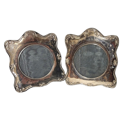 95 - A PAIR OF 20TH CENTURY BRITANNIA  SILVER PHOTOGRAPH FRAMES
Having scrolled frame with ebonised woode... 