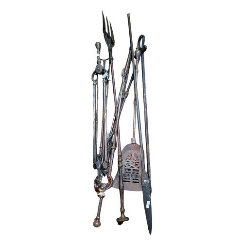192A - A COLLECTION OF VARIOUS VICTORIAN WROUGHT IRON FIREPLACE ACCESSORIES 
Including fireplace tongs, til... 